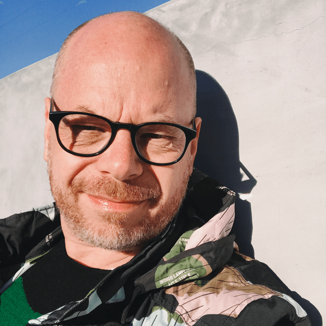 Portrait of a man wearing black frame glasses.