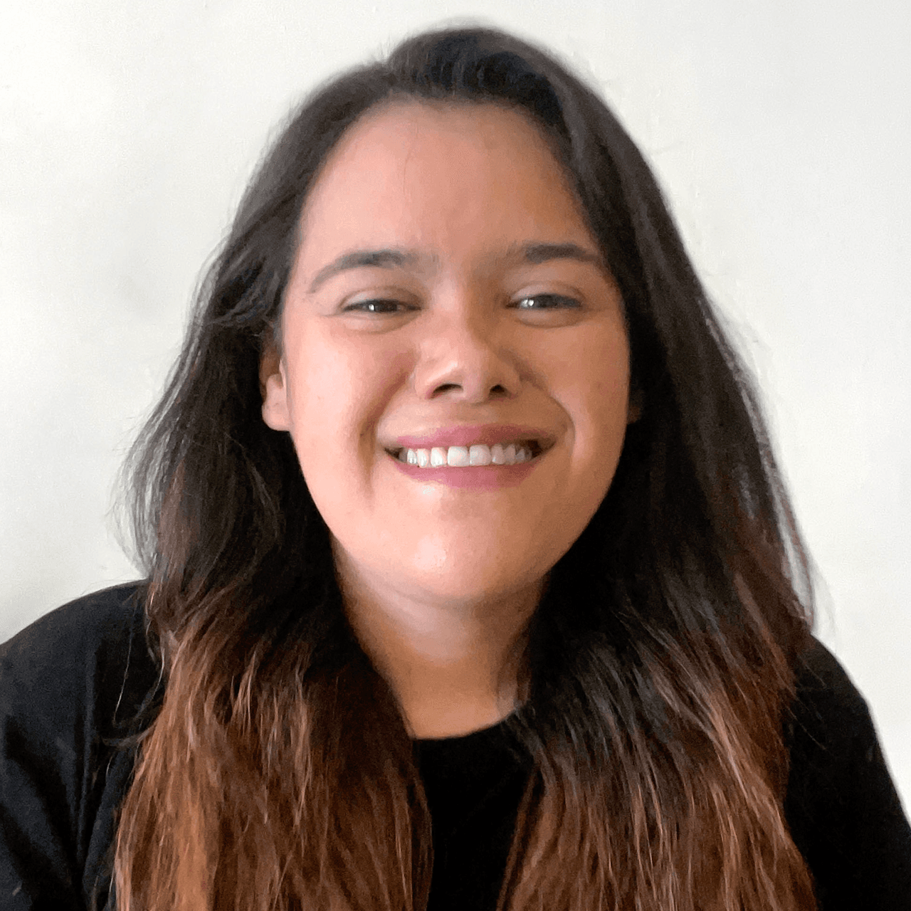 Portrait of a woman with long hair standing on a white background