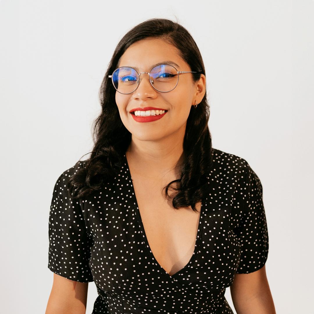 Image of a woman wearing glasses with long dark hair on a white background.